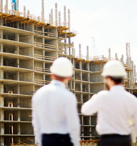 New unfinished structure and two engineers in front